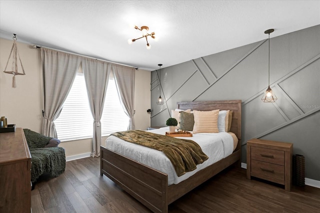 bedroom with baseboards and wood finished floors