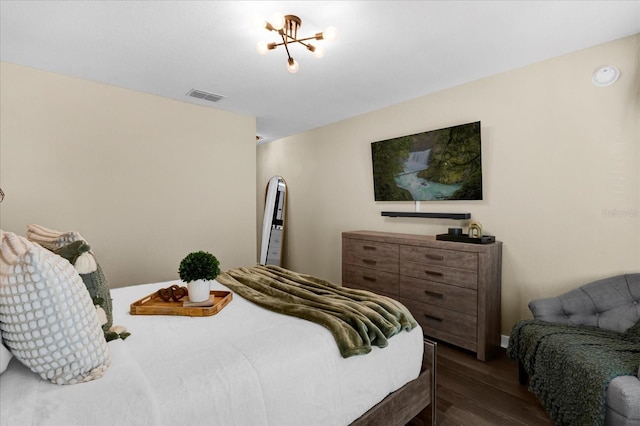 bedroom featuring visible vents and wood finished floors