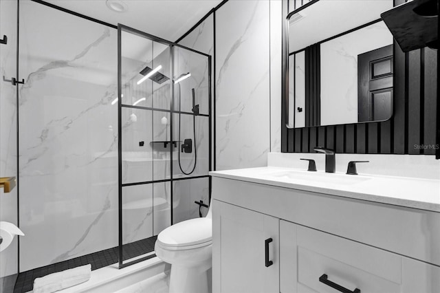 full bathroom with a marble finish shower, toilet, and vanity