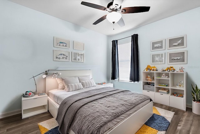 bedroom featuring a ceiling fan, wood finished floors, and baseboards