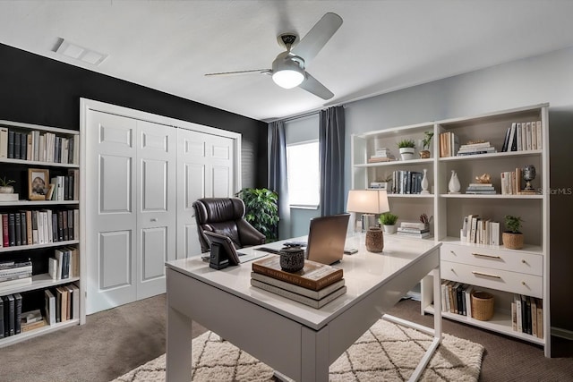 home office featuring visible vents, ceiling fan, and carpet floors