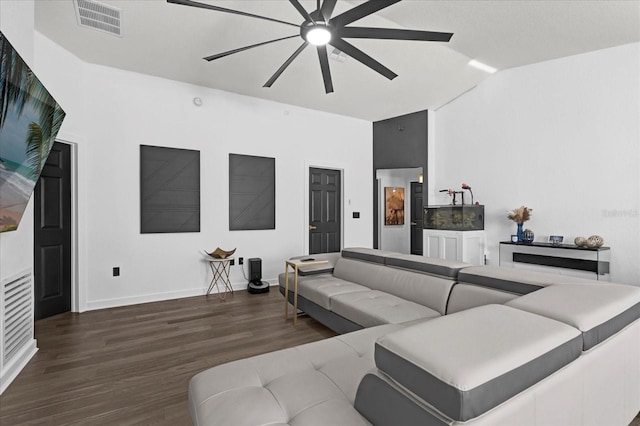 living room featuring visible vents, baseboards, lofted ceiling, wood finished floors, and a ceiling fan