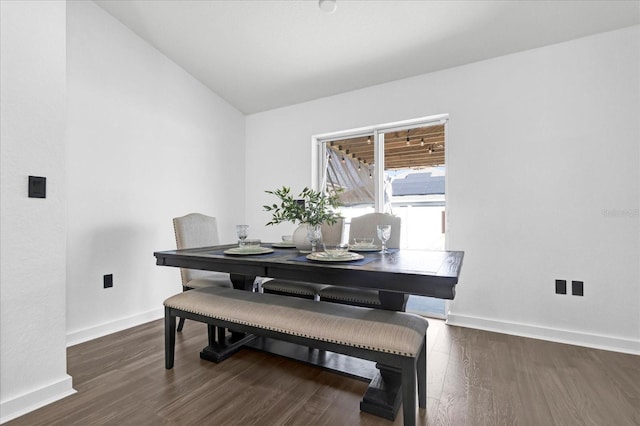 dining room featuring baseboards, lofted ceiling, and wood finished floors