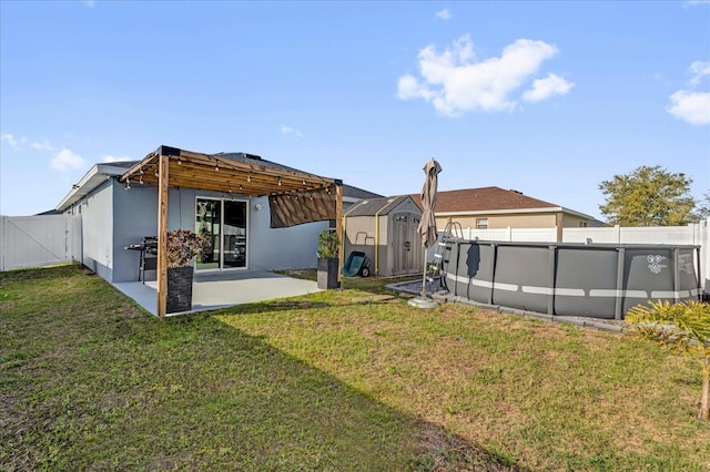 rear view of property with an outbuilding, a storage unit, a fenced backyard, and a yard