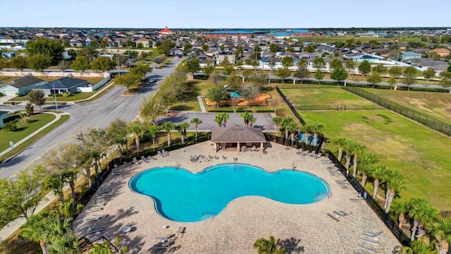 community pool featuring a gazebo, a residential view, a patio, and fence