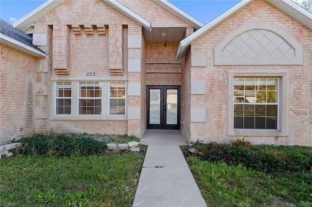 property entrance with french doors and brick siding