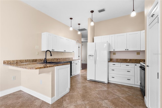 kitchen featuring visible vents, a peninsula, white refrigerator with ice dispenser, black range with electric stovetop, and white cabinetry