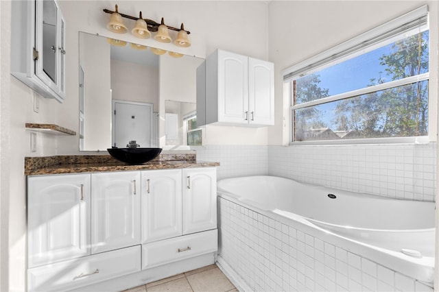 full bathroom featuring tile patterned flooring, vanity, and a garden tub