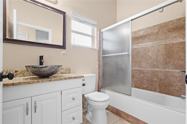 full bathroom featuring enclosed tub / shower combo, toilet, tile patterned floors, and vanity