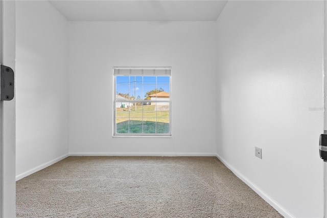 empty room with baseboards and carpet floors