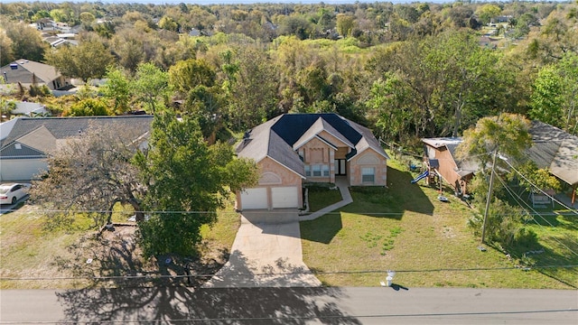 birds eye view of property featuring a wooded view