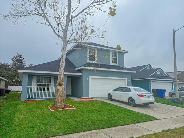 traditional home featuring a shingled roof, a front lawn, concrete driveway, stucco siding, and an attached garage