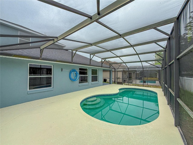 pool featuring a lanai and a patio