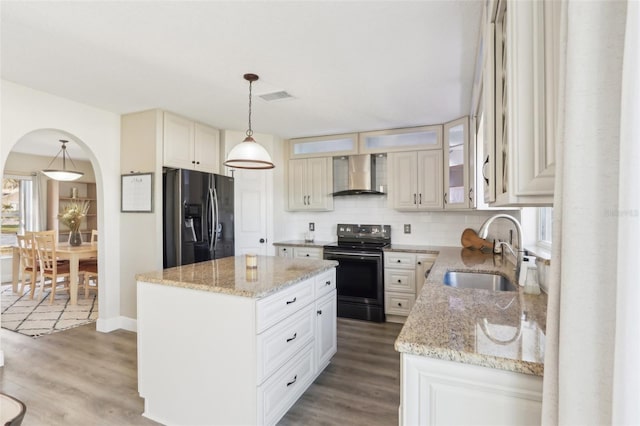 kitchen with visible vents, refrigerator with ice dispenser, electric range, wall chimney exhaust hood, and a sink