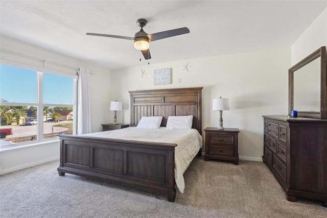 carpeted bedroom with baseboards and ceiling fan