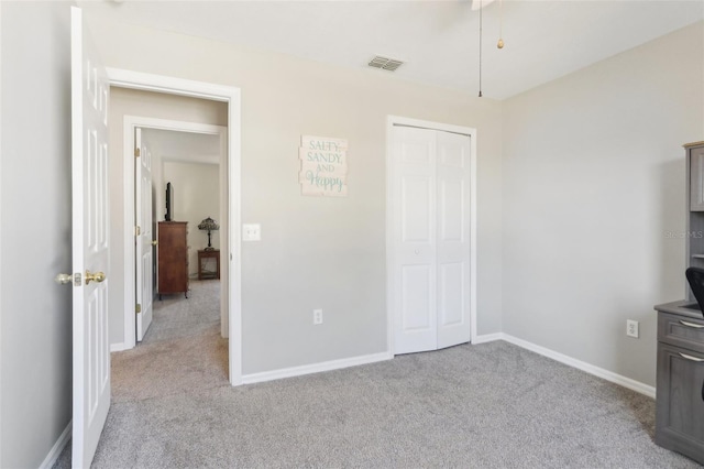 unfurnished bedroom with visible vents, baseboards, and carpet floors