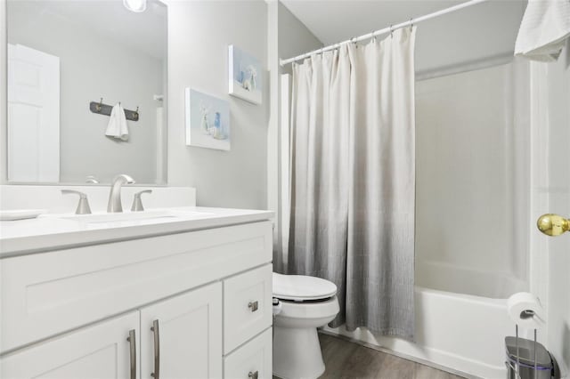 full bath featuring shower / tub combo with curtain, toilet, wood finished floors, and vanity