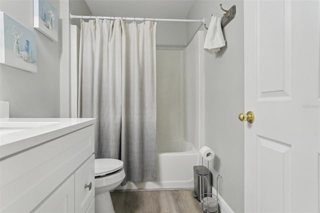 bathroom with toilet, wood finished floors, vanity, and shower / bath combination with curtain