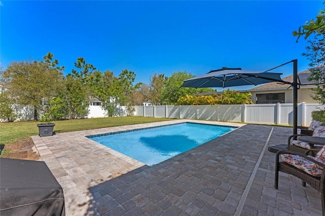 view of pool featuring a fenced in pool, a lawn, a fenced backyard, and a patio area