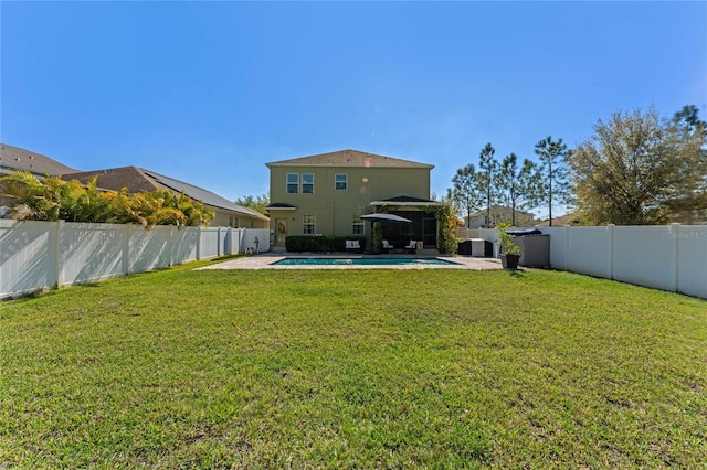 view of yard with a fenced in pool, a fenced backyard, and a patio area