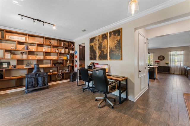 office space featuring visible vents, ornamental molding, dark wood finished floors, baseboards, and a wood stove