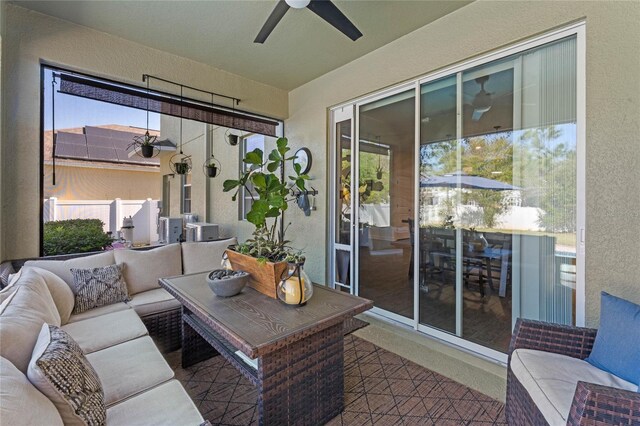 sunroom / solarium with a ceiling fan