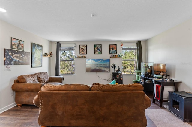 living room featuring baseboards and dark wood-style flooring