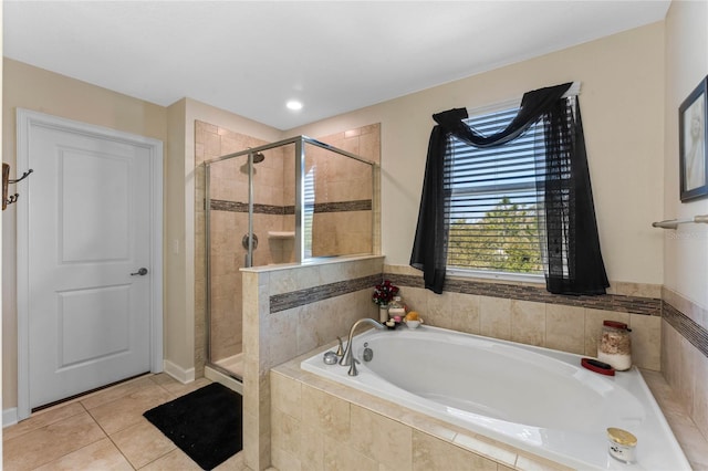 full bath with tile patterned floors, a bath, and a stall shower