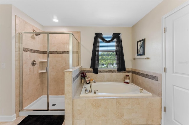 full bath featuring a garden tub and a stall shower