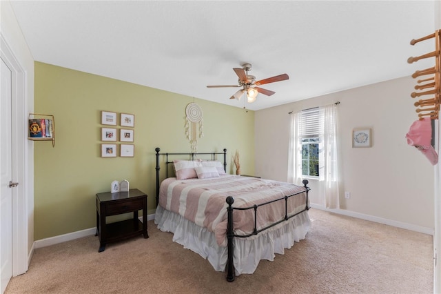 bedroom featuring a ceiling fan, light colored carpet, and baseboards