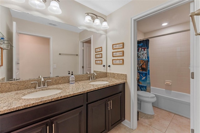 full bathroom featuring a sink, toilet, double vanity, and tile patterned flooring