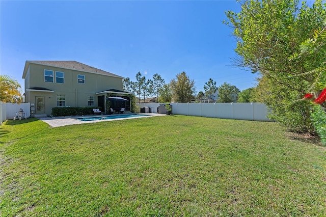 view of yard featuring a patio area, a fenced in pool, and a fenced backyard