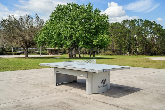 view of property's community featuring a lawn and volleyball court