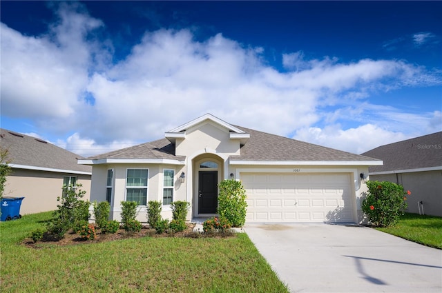 ranch-style home featuring stucco siding, driveway, roof with shingles, a front yard, and a garage