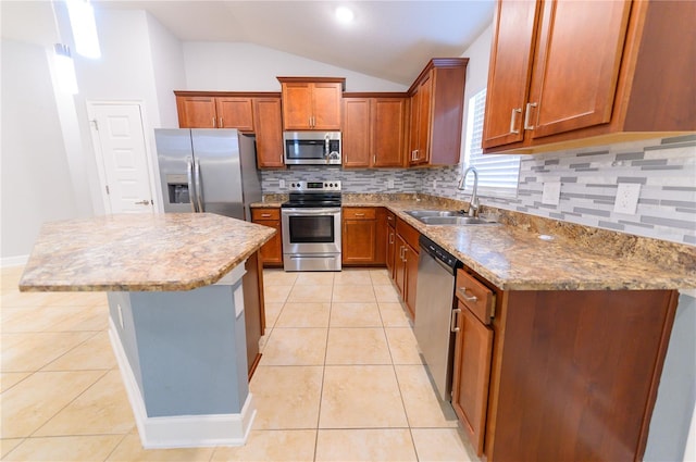 kitchen featuring a sink, a center island, appliances with stainless steel finishes, light tile patterned flooring, and vaulted ceiling