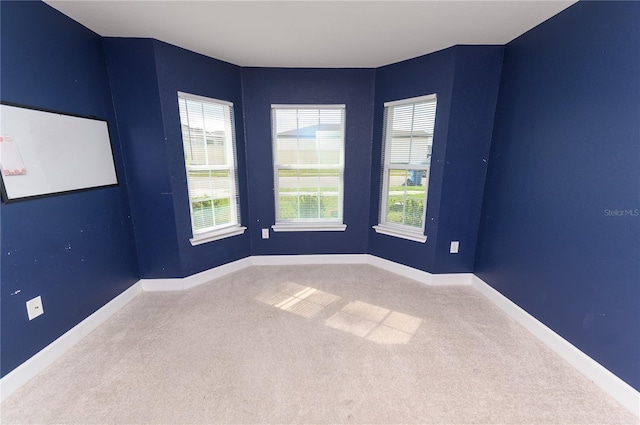 unfurnished room featuring baseboards and carpet flooring