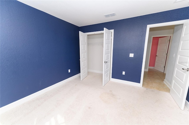 unfurnished bedroom featuring visible vents, baseboards, and carpet