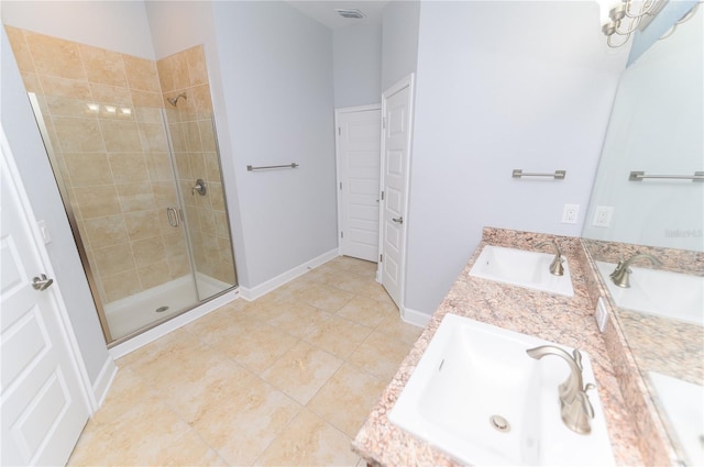 full bath featuring double vanity, visible vents, a stall shower, and a sink