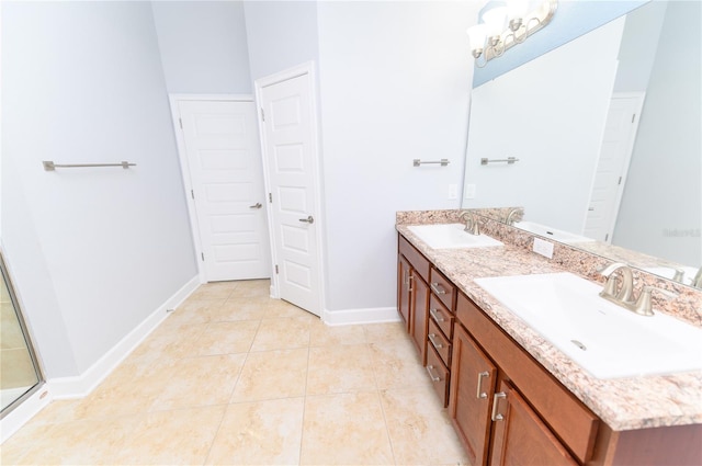 full bathroom with a sink, baseboards, double vanity, and tile patterned floors