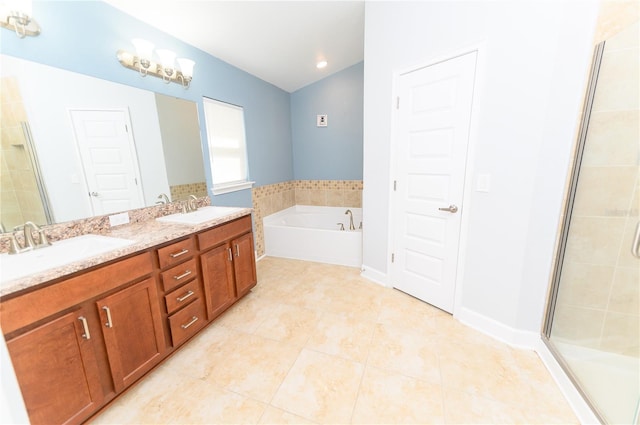 bathroom featuring tile patterned flooring, a shower stall, a garden tub, and a sink