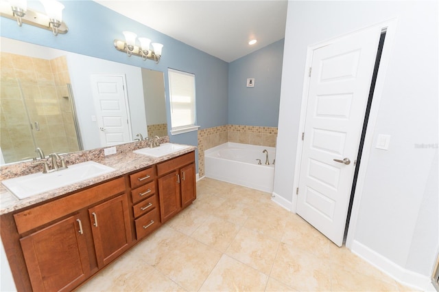 bathroom featuring a shower stall, a garden tub, tile patterned floors, and a sink