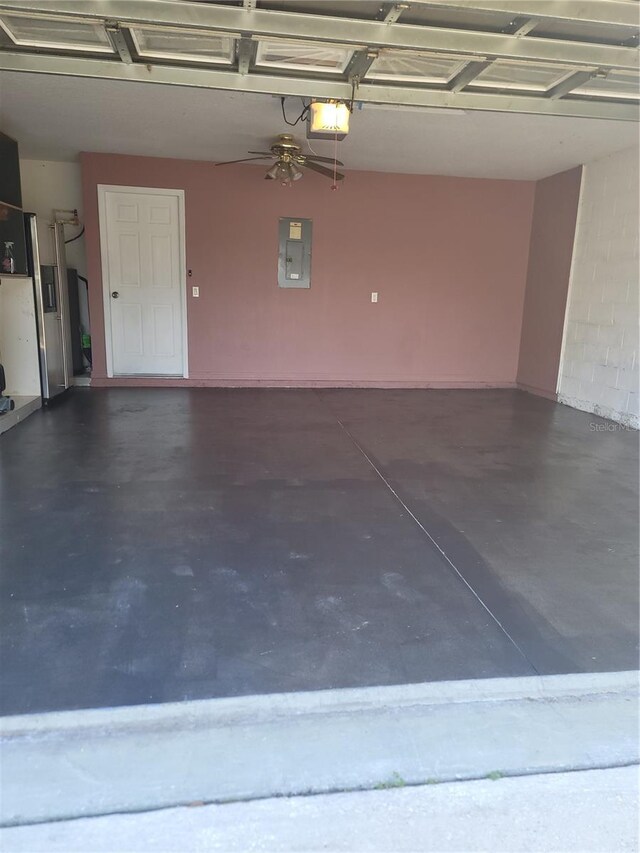 garage featuring electric panel and a garage door opener