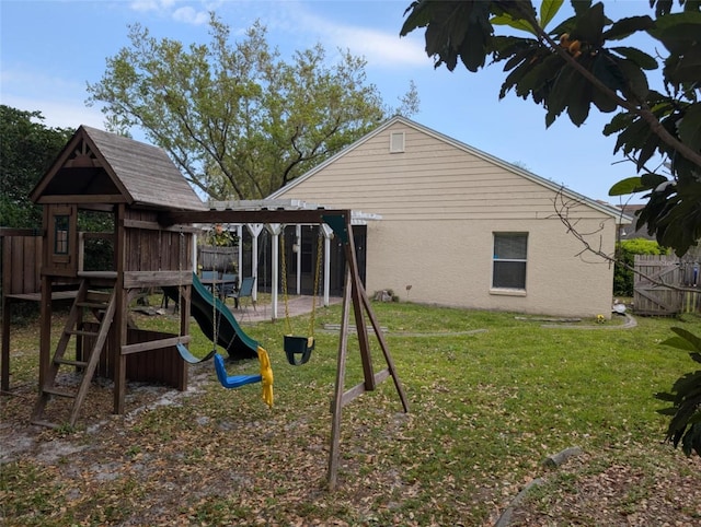 view of play area with a lawn and fence