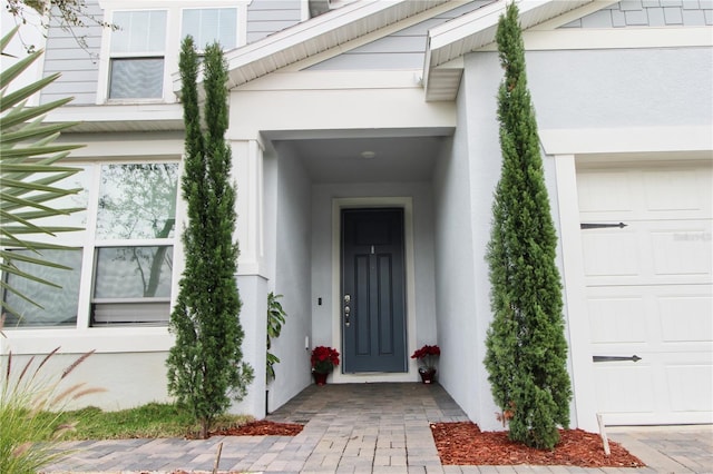 view of exterior entry with stucco siding