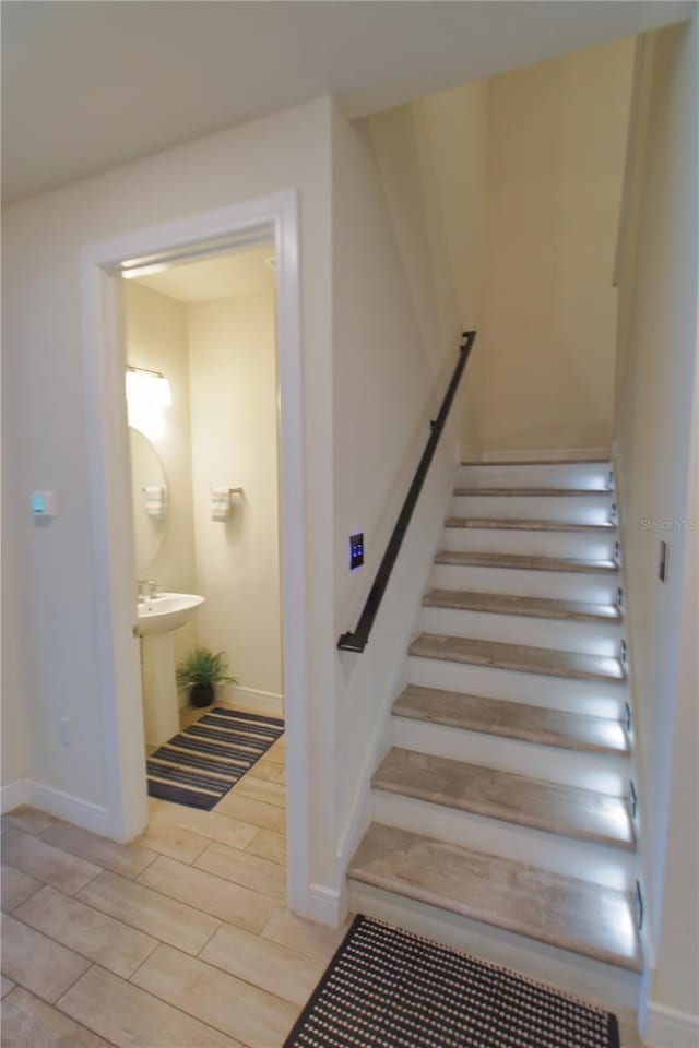 staircase featuring baseboards