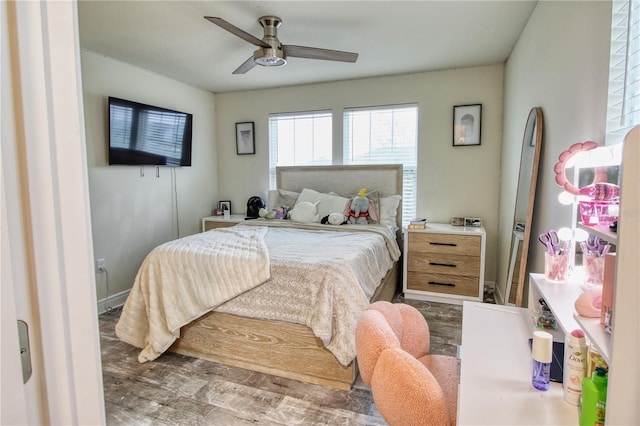 bedroom with a ceiling fan and wood finished floors