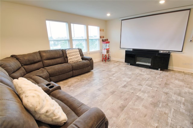 cinema room with recessed lighting, light wood-type flooring, and baseboards