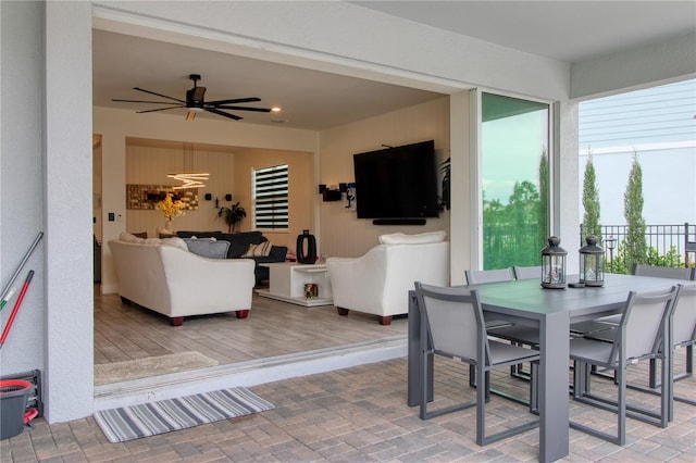 dining area featuring brick floor and ceiling fan