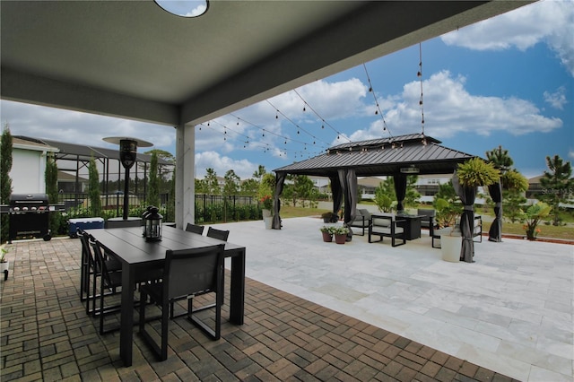 view of patio with a gazebo, outdoor dining area, fence, and grilling area