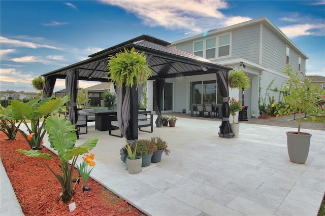 rear view of property with a gazebo and a patio area